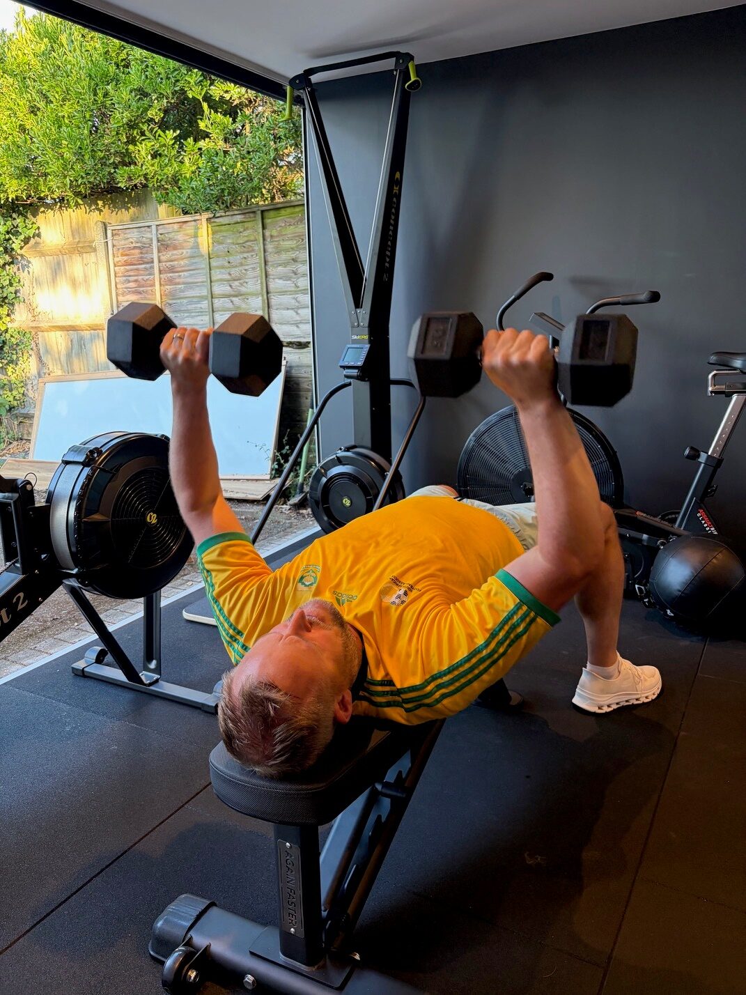 Client lifting weights on a bench